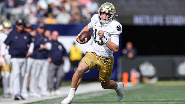 Oct 26, 2024; East Rutherford, New Jersey, USA;Notre Dame Fighting Irish quarterback Riley Leonard (13) carries the ball during the first half against the Navy Midshipmen at MetLife Stadium. Mandatory Credit: Vincent Carchietta-Imagn Images