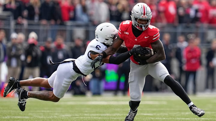 Ohio State Buckeyes wide receiver Jeremiah Smith (4) catches a pass in front of Penn State Nittany Lions safety Zakee Wheatley (6) during the NCAA football game at Ohio Stadium in Columbus on Nov. 1, 2025. Ohio State Buckeyes wide receiver Jeremiah Smith (4) catches a pass in front of Penn State Nittany Lions safety Zakee Wheatley (6) during the NCAA football game at Ohio Stadium in Columbus on Nov. 1, 2025.