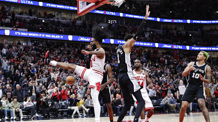 Jan 6, 2025; Chicago, Illinois, USA; Chicago Bulls guard Coby White (0) celebrates after dunking the ball against San Antonio Spurs center Victor Wembanyama (1) during the second half at United Center. Mandatory Credit: Kamil Krzaczynski-Imagn Images
