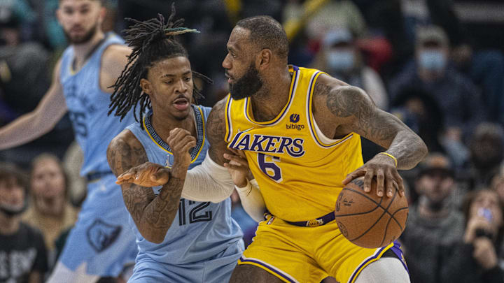 Memphis Grizzlies guard Ja Morant (12) and Los Angeles Lakers forward LeBron James (6) in action during the game between the Los Angeles Lakers and the Memphis Grizzlies at the FedExForum. Mandatory Credit: Jerome Miron-Imagn Images
