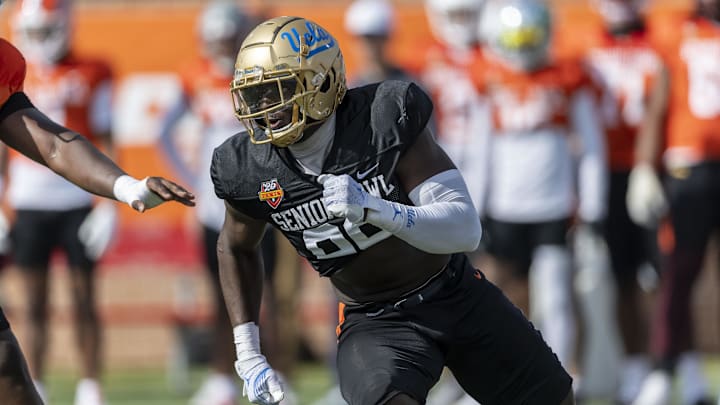 Jan 29, 2025; Mobile, AL, USA; National team defensive lineman Oluwafemi Oladejo of UCLA (99) runs through a drill during Senior Bowl practice at Hancock Whitney Stadium. Mandatory Credit: Vasha Hunt-Imagn Images