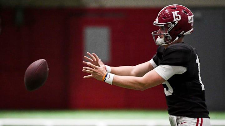 April 9, 2024; Tuscaloosa, Alabama, USA; Alabama quarterback Ty Simpson (15) takes a snap during practice in the Hank Crisp Indoor Practice Facility at the University of Alabama.