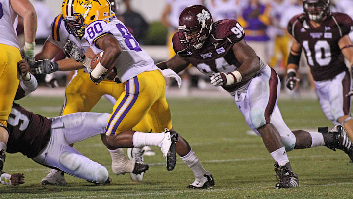 Sep 15, 2011; Starkville, MS, USA; Mississippi State Bulldogs defensive lineman Fletcher Cox (94) pursues Louisiana State Tigers wide receiver Jarvis Landry (80) during the second half at Davis Wade Stadium.  Louisiana State defeat Mississippi State 19-6.  Mandatory Credit: Spruce Derden-Imagn Images