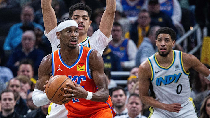 Dec 26, 2024; Indianapolis, Indiana, USA; Oklahoma City Thunder guard Shai Gilgeous-Alexander (2) looks to pass the ball while Indiana Pacers guard Ben Sheppard (26) defends in the first half at Gainbridge Fieldhouse. Mandatory Credit: Trevor Ruszkowski-Imagn Images