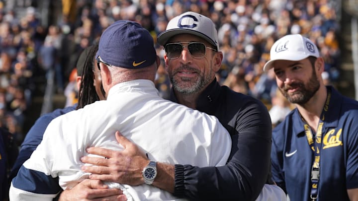 Former Cal quarterback Aaron Rodgers hugs Jeff Tedford, who was Cal's hed coach in 2004.
