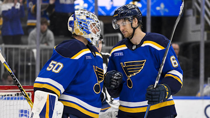 Mar 23, 2025; St. Louis, Missouri, USA;  St. Louis Blues goaltender Jordan Binnington (50) and defenseman Philip Broberg (6) celebrate after the Blues defeated the Nashville Predators at Enterprise Center. Mandatory Credit: Jeff Curry-Imagn Images