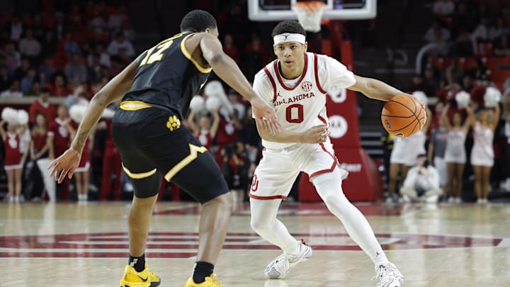 Mar 5, 2025; Norman, Oklahoma, USA; Oklahoma Sooners guard Jeremiah Fears (0) dribbles down the court against Missouri Tigers guard Tony Perkins (12) during the second half at Lloyd Noble Center. Mandatory Credit: Alonzo Adams-Imagn Images