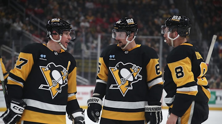 Feb 22, 2025; Pittsburgh, Pennsylvania, USA; Pittsburgh Penguins center Sidney Crosby (87) talks with defenseman Erik Karlsson (65) and left wing Michael Bunting (8) against the Washington Capitals during the first period at PPG Paints Arena. Mandatory Credit: Charles LeClaire-Imagn Images