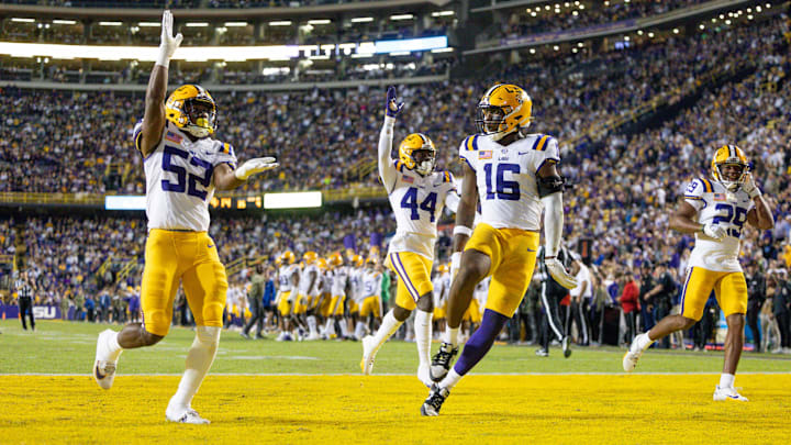 Nov 11, 2023; Baton Rouge, Louisiana, USA;  LSU Tigers cornerback Jeremiah Hughes (29) and linebacker Princeton Malbrue (52) and defensive end Da'Shawn Womack (16) react to a play against the Florida Gators during the second half at Tiger Stadium. Mandatory Credit: Stephen Lew-Imagn Images