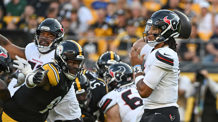 Aug 9, 2024; Pittsburgh, Pennsylvania, USA;  Houston Texans quarterback C.J. Stroud (7) throws a pass while being pressured by Pittsburgh Steelers defensive tackle Keeanu Benton during the first quarter at Acrisure Stadium. Mandatory Credit: Barry Reeger-Imagn Images
