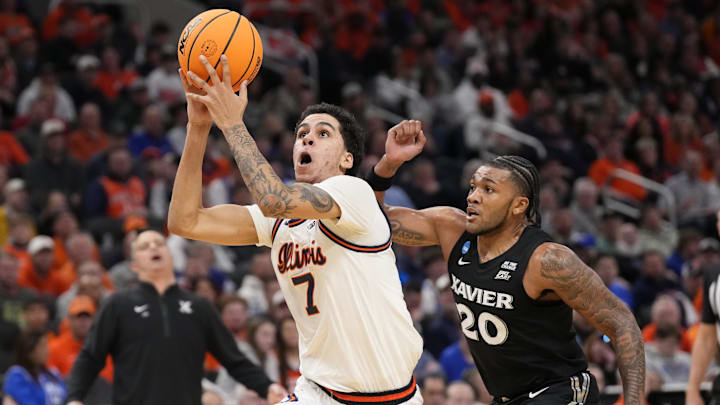 Mar 21, 2025; Milwaukee, WI, USA: Illinois Fighting Illini forward Will Riley (7) drives to the hoop past Xavier Musketeers guard Dayvion McKnight (20) during the first half at Fiserv Forum. Mandatory Credit: Jeff Hanisch-Imagn Images
