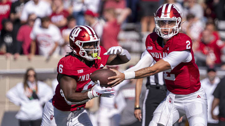 Oct 19, 2024; Bloomington, Indiana, USA; Indiana Hoosiers quarterback Tayven Jackson (2) hands the ball off to Indiana Hoosiers running back Justice Ellison (6) during the fourth quarter of a game against the Nebraska Cornhuskers at Memorial Stadium. Mandatory Credit: Jacob Musselman-Imagn Images