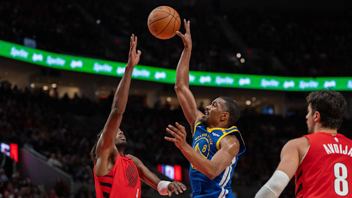 Oct 23, 2024; Portland, Oregon, USA;  Golden State Warriors shooting guard De'Anthony Melton (8) shoots teh bal over Portland Trailblazers shooting forward Jerami Grant (9) during the second half at Moda Center. Mandatory Credit: Stephen Brashear-Imagn Images