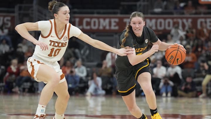 Jan 30, 2025; Austin, Texas, USA; Missouri Tigers guard Grace Slaughter (0) drives to the basket while defended by Texas Longhorns guard Shay Holle (10) during the second half at Moody Center. Mandatory Credit: Scott Wachter-Imagn Images