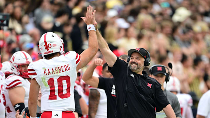Sep 28, 2024; West Lafayette, Indiana, USA; Nebraska Cornhuskers head coach Matt Rhule high fives quarterback Heinrich Haarberg (10) during the first quarter against the Purdue Boilermakers at Ross-Ade Stadium. Mandatory Credit: Marc Lebryk-Imagn Images
