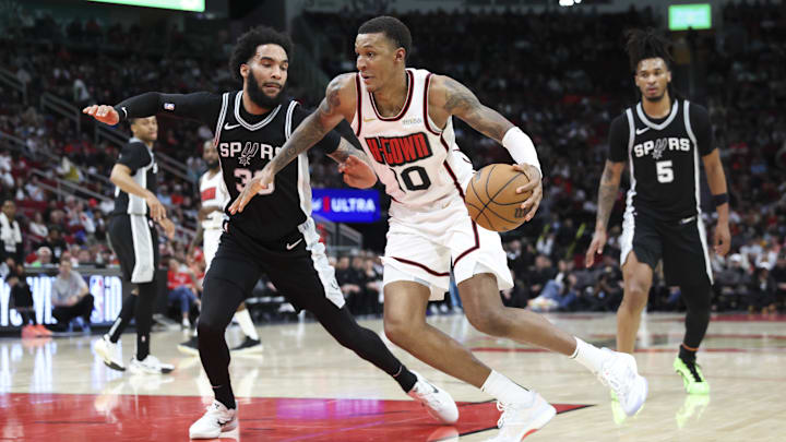 Feb 26, 2025; Houston, Texas, USA; Houston Rockets forward Jabari Smith Jr. (10) dribble the ball as San Antonio Spurs forward Julian Champagnie (30) defends during the fourth quarter at Toyota Center. Mandatory Credit: Troy Taormina-Imagn Images