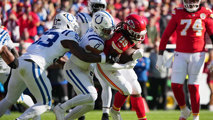 Nov 23, 2025; Kansas City, Missouri, USA; Indianapolis Colts safety Cam Bynum (0) tackles Kansas City Chiefs running back Kareem Hunt (29) in the first quarter at GEHA Field at Arrowhead Stadium. Mandatory Credit: Denny Medley-Imagn Images