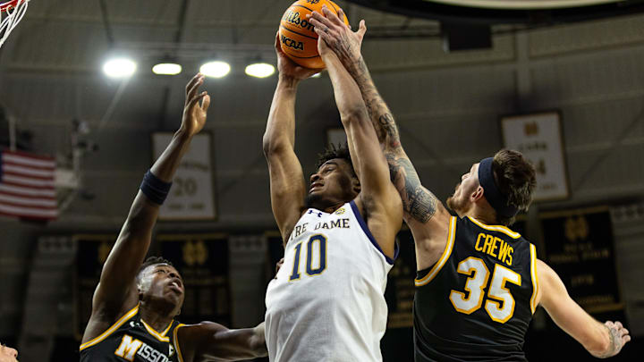Dec 2, 2025; South Bend, Indiana, USA; Notre Dame Fighting Irish guard Jalen Haralson (10) fights for a rebound against Missouri Tigers forward Mark Mitchell (25) and Missouri Tigers guard Jacob Crews (35) during the first half at Purcell Pavilion at the Joyce Center. Mandatory Credit: Michael Caterina-Imagn Images
