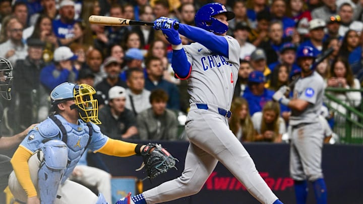May 2, 2025; Milwaukee, Wisconsin, USA; Chicago Cubs center fielder Pete Crow-Armstrong (4) hits a solo home run in the second inning as Milwaukee Brewers catcher William Contreras (24) looks on at American Family Field.