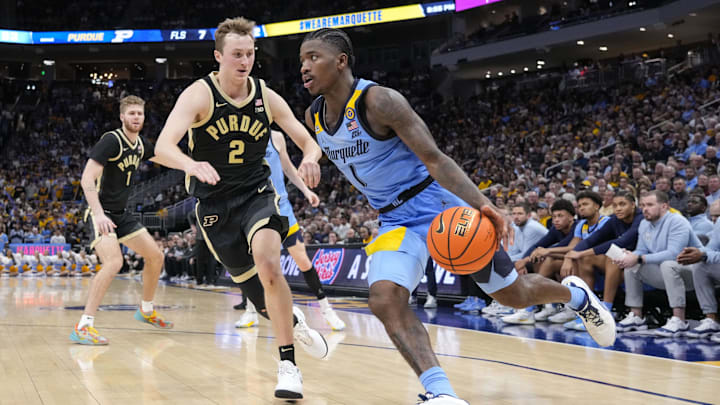 Marquette Golden Eagles guard Kam Jones (1) drives towards the basket around Purdue Boilermakers guard Fletcher Loyer (2) Marquette Golden Eagles guard Kam Jones (1) drives towards the basket around Purdue Boilermakers guard Fletcher Loyer (2)