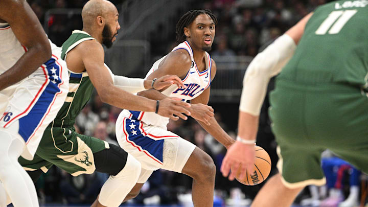 Mar 4, 2023; Milwaukee, Wisconsin, USA; Philadelphia 76ers guard Tyrese Maxey (0) drives to the basket against Milwaukee Bucks guard Jevon Carter (5) in the second half  at Fiserv Forum. Mandatory Credit: Michael McLoone-Imagn Images