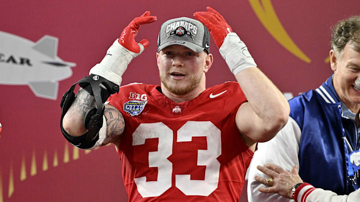 Jan 10, 2025; Arlington, Texas, USA; Ohio State Buckeyes defensive end Jack Sawyer (33) celebrates after winning the College Football Playoff semifinal against the Texas Longhorns in the Cotton Bowl at AT&T Stadium. Mandatory Credit: Jerome Miron-Imagn Images