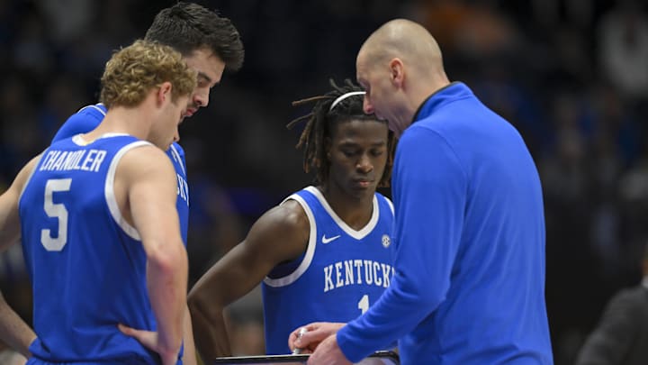 Mar 12, 2026; Nashville, TN, USA;  Kentucky Wildcats head coach Mark Pope talks with Kentucky Wildcats guard Denzel Aberdeen (1), forward Andrija Jelavic (4), and guard Collin Chandler (5) during a time out against the Missouri Tigers during the first half at Bridgestone Arena. Mandatory Credit: Steve Roberts-Imagn Images