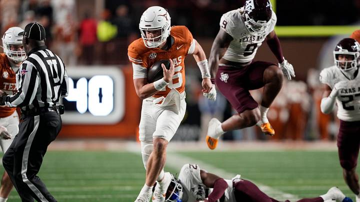 Texas Longhorns quarterback Arch Manning keeps the ball and runs for a touchdown during the second half against the Texas A&M Aggies Texas Longhorns quarterback Arch Manning keeps the ball and runs for a touchdown during the second half against the Texas A&M Aggies