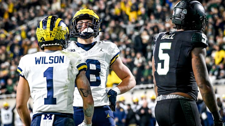 Michigan's Colston Loveland, center, poses like Paul Bunyan while celebrating his touchdown with teammate Roman Wilson as Michigan State's Jordan Hall, right, looks on during the second quarter on Saturday, Oct. 21, 2023, at Spartan Stadium in East Lansing. Michigan's Colston Loveland, center, poses like Paul Bunyan while celebrating his touchdown with teammate Roman Wilson as Michigan State's Jordan Hall, right, looks on during the second quarter on Saturday, Oct. 21, 2023, at Spartan Stadium in East Lansing.