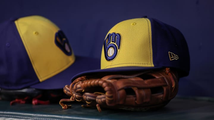 Jul 28, 2023; Atlanta, Georgia, USA; A detailed view of a Milwaukee Brewers hat and glove on the bench against the Atlanta Braves in the second inning at Truist Park. Mandatory Credit: Brett Davis-Imagn Images