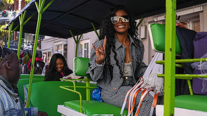 Loreal Sarkisian, wife of Texas Longhorns head coach Steve Sarkisian, holds up the sign of the Horns.