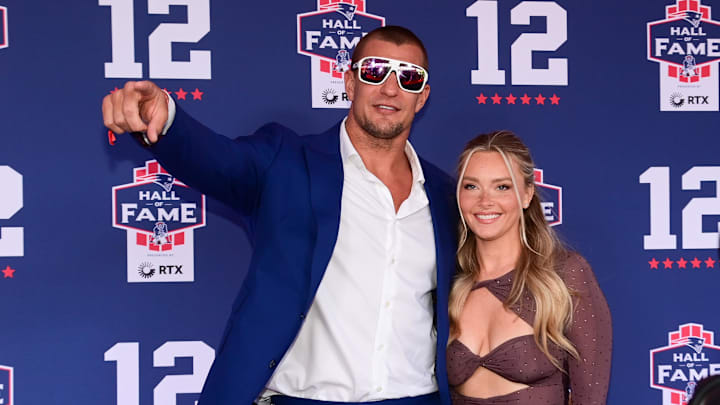 Jun 12, 2024; Foxborough, MA, USA; Retired NFL tight end Rob Gronkowski poses for photos with his girlfriend Camille Kostek during the New England Patriots Hall of Fame induction Ceremony for Tom Brady Mandatory Credit: Eric Canha-Imagn Images