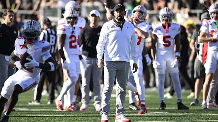 Oct 12, 2024; Eugene, Oregon, USA; Ohio State Buckeyes head coach Ryan Day watches players warm up before a game against the Oregon Ducks at Autzen Stadium. Mandatory Credit: Troy Wayrynen-Imagn Images