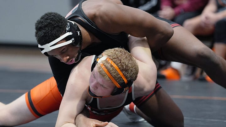 Fort Dodge's Dreshaun Ross, top, wrestles Ames' Tyson Grosz in a 215-pound match at Harrison Barnes Gymnasium in Ames on Jan. 16.