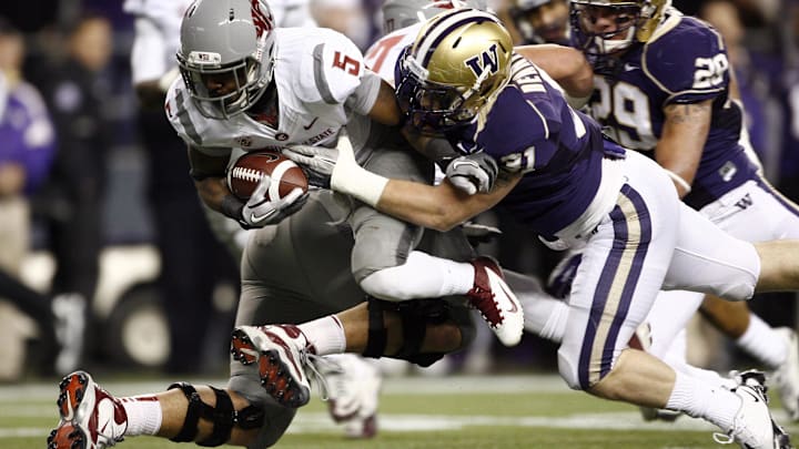 WSU running back Rickey Galvin gets tackled by Huskies linebacker Cort Dennison in 2011 at Century Link Field. WSU running back Rickey Galvin gets tackled by Huskies linebacker Cort Dennison in 2011 at Century Link Field.