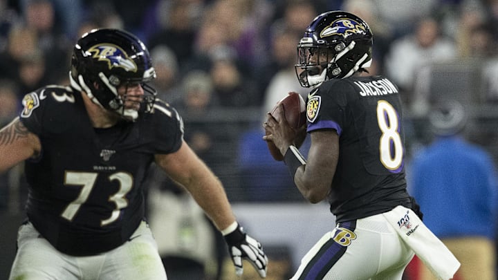 Nov 3, 2019; Baltimore, MD, USA; Baltimore Ravens quarterback Lamar Jackson (8) looks to pass was guard Marshal Yanda (73) blocks during the second half against the New England Patriots at M&T Bank Stadium. Mandatory Credit: Tommy Gilligan-Imagn Images