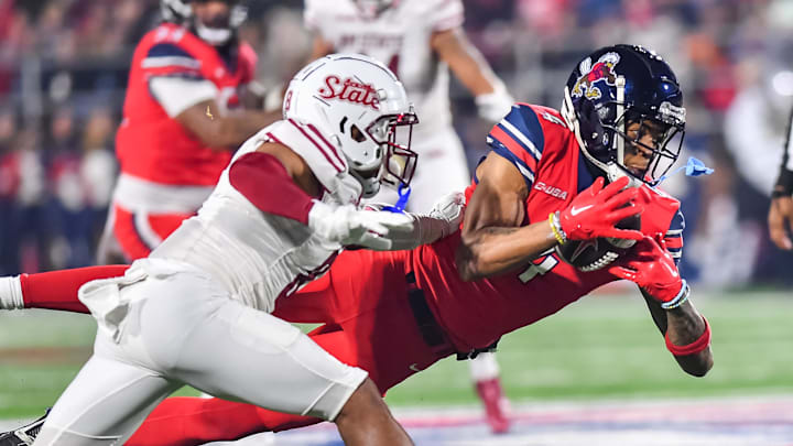 Dec 1, 2023; Lynchburg, VA, USA; Liberty Flames wide receiver CJ Daniels (4) catches a pass against the New Mexico State Aggies during the first quarter at Williams Stadium. Mandatory Credit: Brian Bishop-USA TODAY Sports