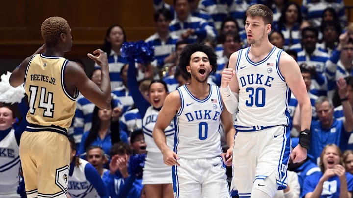 Jan 13, 2024; Durham, North Carolina, USA; Duke Blue Devils center Kyle Filipowski (30) reacts after scoring as Georgia Tech Yellow Jackets guard Kowacie Reeves Jr. (14) and Duke guard Jared McCain (0) look on during the first half at Cameron Indoor Stadium. Mandatory Credit: Rob Kinnan-USA TODAY Sports