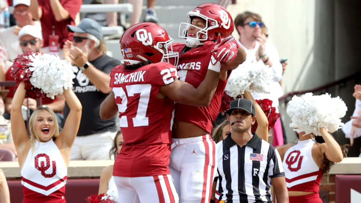 Oklahoma's Nic Anderson (4) celebrates his touchdown with Gavin Sawchuk (27) lin the first half of the college football game between the University of Oklahoma Sooners and the University of Central Florida Knights at Gaylord Family Oklahoma-Memorial Stadium in Norman, Okla., Saturday, Oct., 21, 2023.