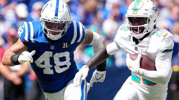 Sep 7, 2025; Indianapolis, Indiana, USA; Indianapolis Colts linebacker Joe Bachie (48) attempts to bring down Miami Dolphins running back De'Von Achane (28) during the second half of a game at Lucas Oil Stadium. Mandatory Credit: Christine Tannous-USA TODAY Network via Imagn Images