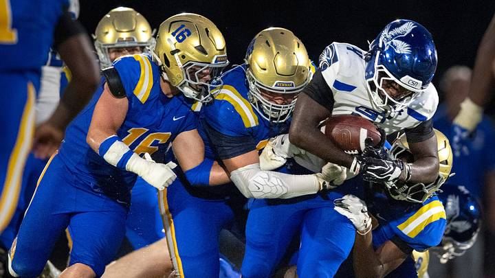 Community School of Naples' Louvens Bazille is stopped by the Cardinal Newman defense in West Palm Beach on Aug, 21, 2026. Cardinal Newman ran its record to 2-0 last week when it held off Cardinal Mooney, 47-46, in a battle of defending state champions. Community School of Naples' Louvens Bazille is stopped by the Cardinal Newman defense in West Palm Beach on Aug, 21, 2026. Cardinal Newman ran its record to 2-0 last week when it held off Cardinal Mooney, 47-46, in a battle of defending state champions.