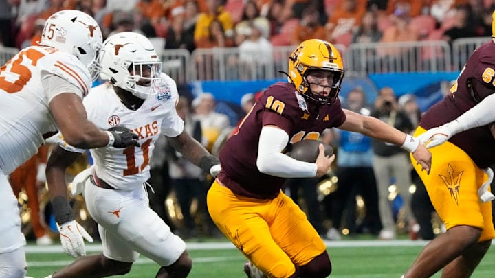 Arizona State quarterback Sam Leavitt (10) scrambles away from Texas linebacker Colin Simmons (11) during the second quarter of the Chick-fil-A Peach Bowl in Atlanta on Wednesday, Jan. 1, 2025.