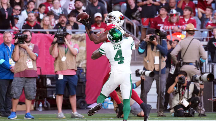 Nov 10, 2024; Glendale, Arizona, USA; Arizona Cardinals wide receiver Marvin Harrison Jr. (18) catches a touchdown pas against New York Jets cornerback D.J. Reed (4) during the first half at State Farm Stadium. Mandatory Credit: Joe Camporeale-Imagn Images Nov 10, 2024; Glendale, Arizona, USA; Arizona Cardinals wide receiver Marvin Harrison Jr. (18) catches a touchdown pas against New York Jets cornerback D.J. Reed (4) during the first half at State Farm Stadium. Mandatory Credit: Joe Camporeale-Imagn Images