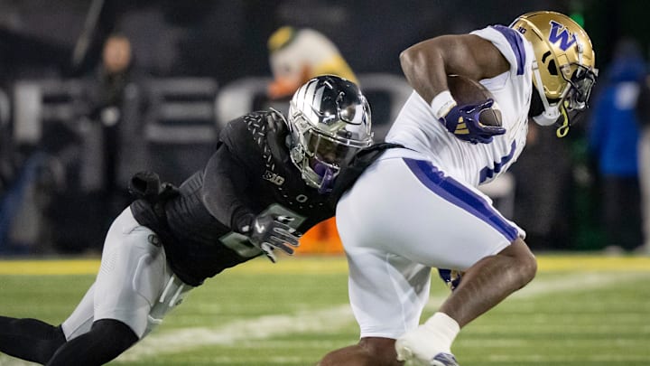 Oregon defensive end Jordan Burch tackles Washington running back Jonah Coleman as the No. 1 Oregon Ducks host the Washington Huskies Saturday, Nov. 30, 2024 at Autzen Stadium in Eugene, Ore.