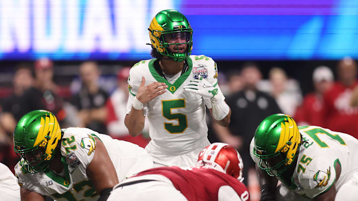 Jan 9, 2026; Atlanta, GA, USA; Oregon Ducks quarterback Dante Moore (5) calls a play on the line of scrimmage against the Indiana Hoosiers during the first quarter of the 2025 Peach Bowl and semifinal game of the College Football Playoff at Mercedes-Benz Stadium. Mandatory Credit: Brett Davis-Imagn Images Jan 9, 2026; Atlanta, GA, USA; Oregon Ducks quarterback Dante Moore (5) calls a play on the line of scrimmage against the Indiana Hoosiers during the first quarter of the 2025 Peach Bowl and semifinal game of the College Football Playoff at Mercedes-Benz Stadium. Mandatory Credit: Brett Davis-Imagn Images