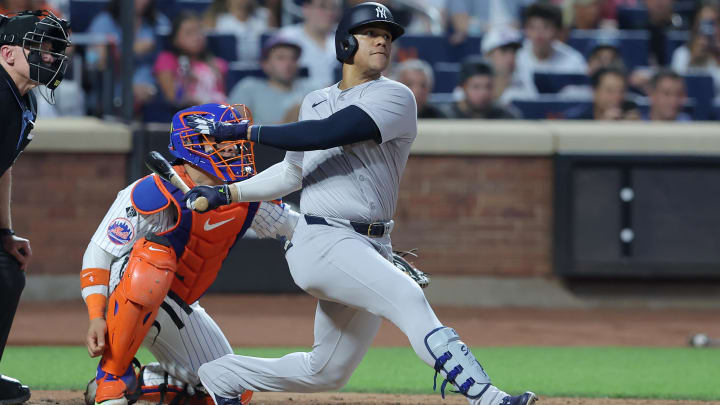 Jun 25, 2024; New York City, New York, USA; New York Yankees right fielder Juan Soto (22) follows through on a solo home run against the New York Mets during the fifth inning at Citi Field. Mandatory Credit: Brad Penner-USA TODAY Sports