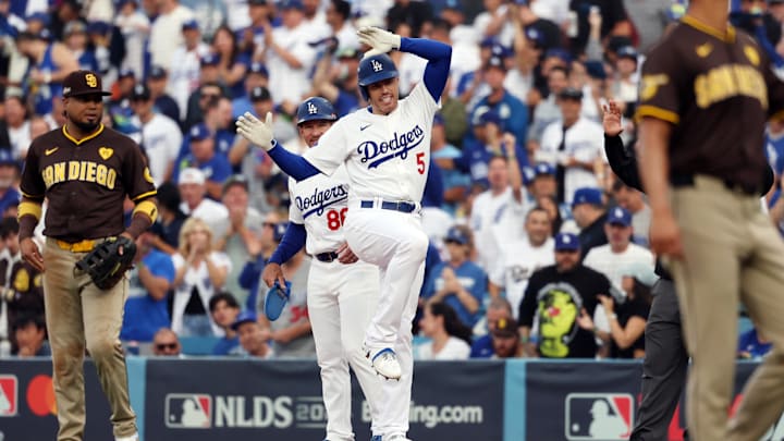 Oct 11, 2024; Los Angeles, California, USA; Los Angeles Dodgers first baseman Freddie Freeman (5) reacts at first base after hitting a single in the first inning against the San Diego Padres during game five of the NLDS for the 2024 MLB Playoffs at Dodger Stadium. Mandatory Credit: Kiyoshi Mio-Imagn Images