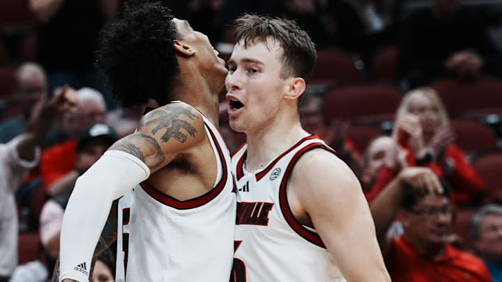 Louisville's Terrence Edwards Jr. (5) got a chest bump from teammate Reyne Smith (6) after Edwards hit a tough shot against Morehead State's Dieonte Miles (23) during their game at the KFC Yum! Center in Louisville, Ky. on Nov. 4, 2024. Louisville's Terrence Edwards Jr. (5) got a chest bump from teammate Reyne Smith (6) after Edwards hit a tough shot against Morehead State's Dieonte Miles (23) during their game at the KFC Yum! Center in Louisville, Ky. on Nov. 4, 2024.