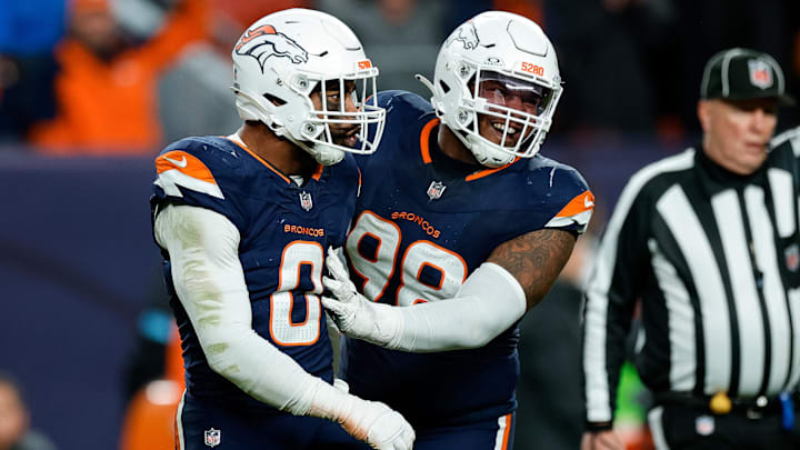 Dec 2, 2024; Denver, Colorado, USA; Denver Broncos linebacker Jonathon Cooper (0) reacts with defensive end John Franklin-Myers (98) after a play in the fourth quarter against the Cleveland Browns at Empower Field at Mile High. 