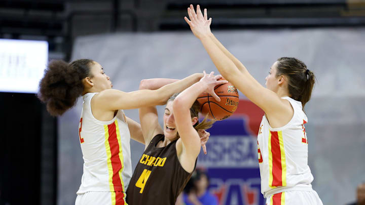 Kickapoo's Mikayla Pilley (4) looks to move the ball defended by Incarnate Word's Nevaeh Caffey (2) and Abbie Sextro (35) during a Class 6 state championship girls basketball game between Kickapoo and Incarnate Word, Saturday, March 16, 2024, at Mizzou Arena in Columbia, Mo.